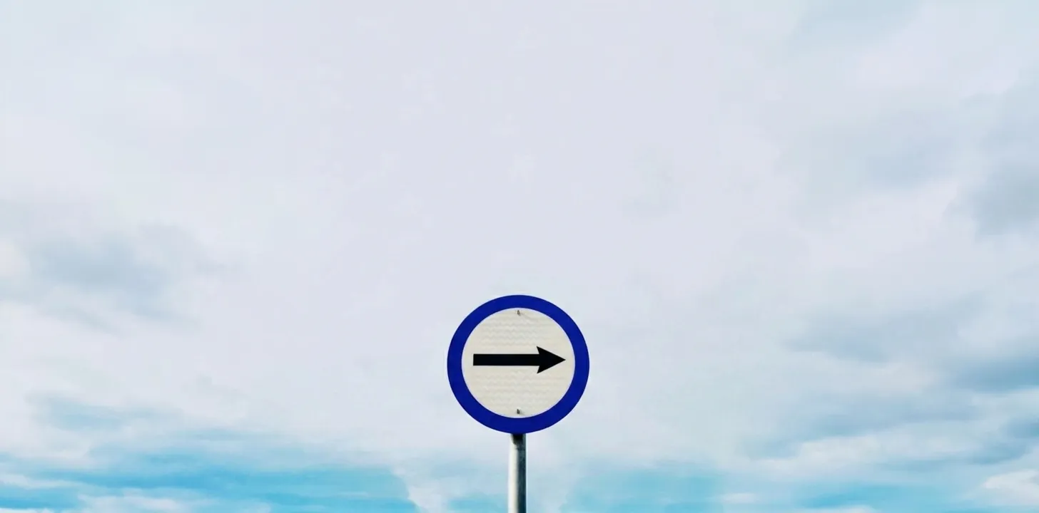 A clear directional arrow sign symbolizing a focused path forward